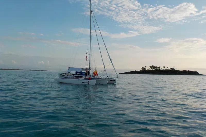 Slide: The Image of Sailboat Corsair F 27 (1991) on calm sea near tropical island. - 8