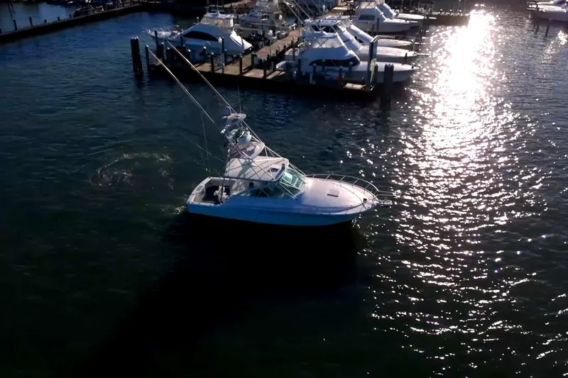 Slide: The Image of Aerial view of 2003 Cabo 40 Express boat in marina at sunset. - 11