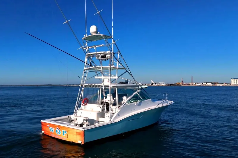 Slide: The Image of 2003 Cabo 40 Express boat on calm blue water under clear sky. - 18