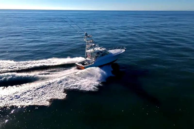 Slide: The Image of 2003 Cabo 40 Express boat cruising on open ocean waters. - 3