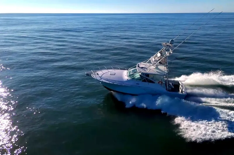 Slide: The Image of 2003 Cabo 40 Express yacht cruising on open ocean waters. - 6