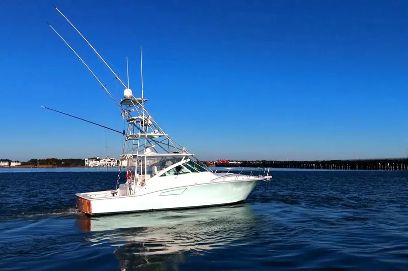 Slide: The Image of 2003 Cabo 40 Express boat cruising on calm blue waters under clear sky. - 8