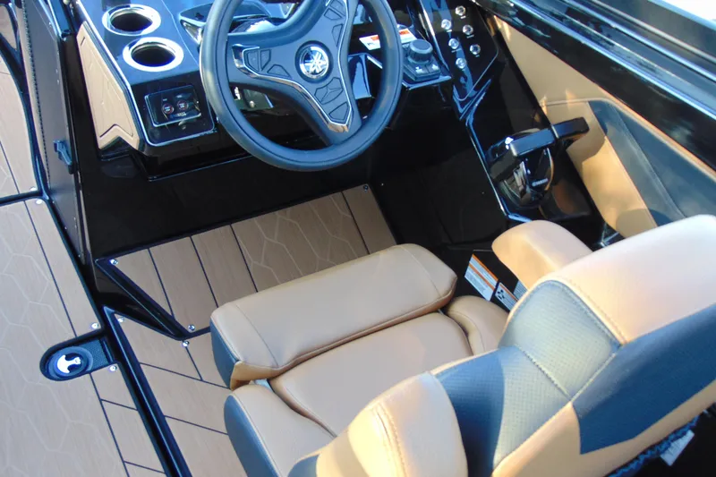 Slide: The Image of 2026 Yamaha Boats 255XD interior with sleek black finish and cup holders. - 12