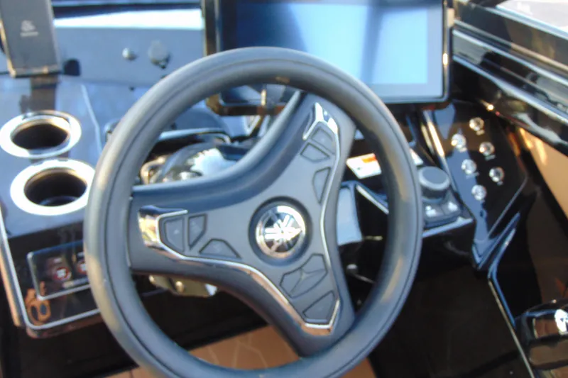 Slide: The Image of 2026 Yamaha Boats 255XD interior with tan and black seating, stylish design, and cup holders. - 15