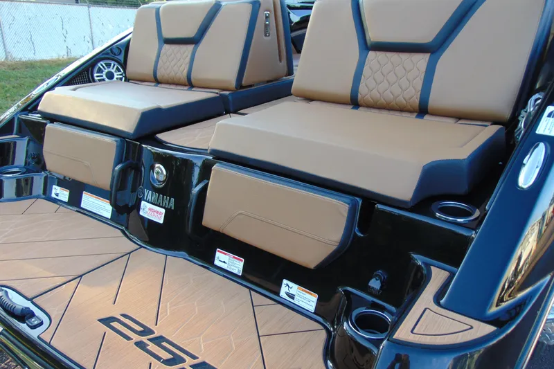Slide: The Image of 2026 Yamaha Boats 255XD interior with tan seating and sleek design. - 2