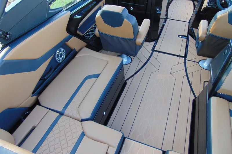 Slide: The Image of 2026 Yamaha Boats 255XD interior with sleek wooden table and storage compartment. - 9