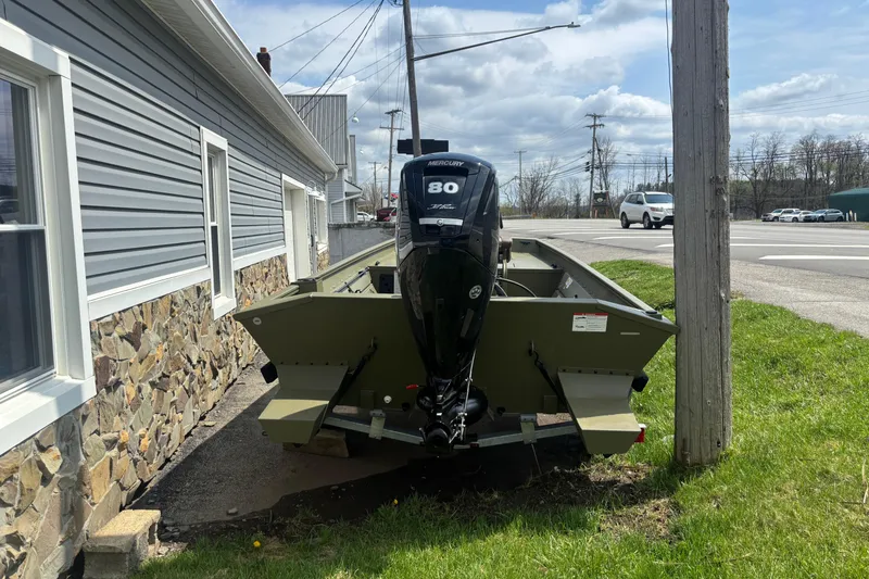 Slide: The Image of 2026 Crestliner 1870 Retriever FCC boat with Mercury 80 engine parked beside a building. - 3