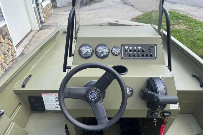 Slide: The Image of 2026 Crestliner 1870 Retriever FCC boat dashboard with steering wheel and control panel. - 6