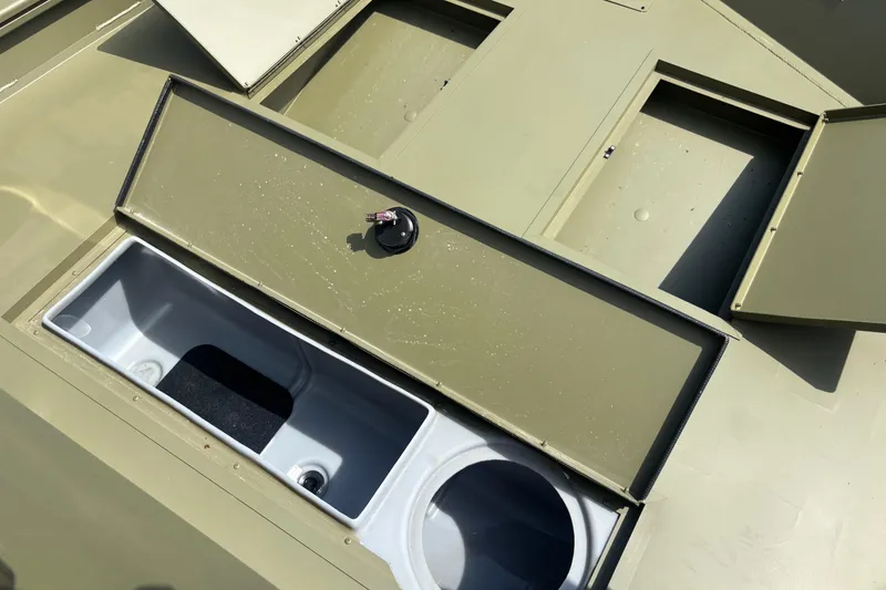 Slide: The Image of 2026 Crestliner 1870 Retriever FCC boat storage compartment with open lid. - 7