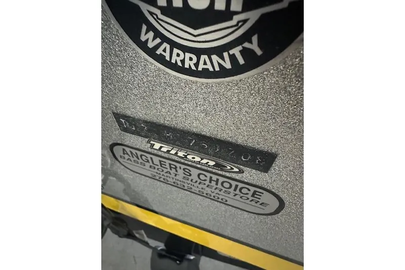 Slide: The Image of Close-up of 2008 Triton 21X2 DC boat warranty and Angler's Choice label. - 11