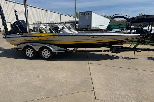 Slide: The Image of 2008 Triton 21X2 DC boat on trailer, parked outdoors. - 13