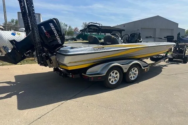 Slide: The Image of 2008 Triton 21X2 DC boat with Mercury engine on trailer, parked outdoors. - 14