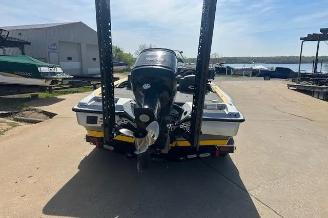 Slide: The Image of 2008 Triton 21X2 DC boat with outboard motor, parked near a lake. - 15
