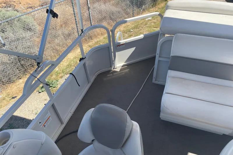 Slide: The Image of 2005 Crestliner Sport Classic 1685 boat interior with white seating and open deck area. - 10