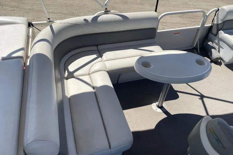 Slide: The Image of 2005 Crestliner Sport Classic 1685 boat interior with cushioned seating and round table. - 3