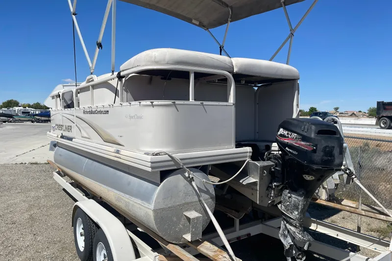 Slide: The Image of 2005 Crestliner Sport Classic 1685 pontoon boat on trailer with outboard motor. - 6