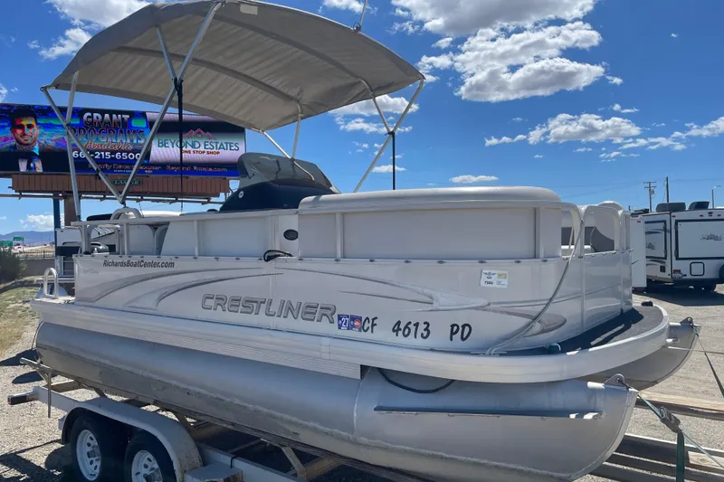 Slide: The Image of 2005 Crestliner Sport Classic 1685 pontoon boat on trailer under blue sky. - 7