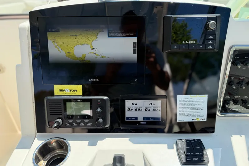 Slide: The Image of Dashboard of a 2021 Cobia 280 Dual Console with Garmin navigation and JL Audio system. - 11