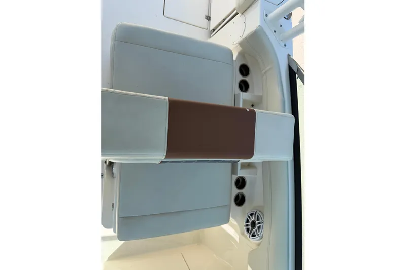 Slide: The Image of 2021 Cobia 280 Dual Console boat seating with cup holders and speaker. - 13