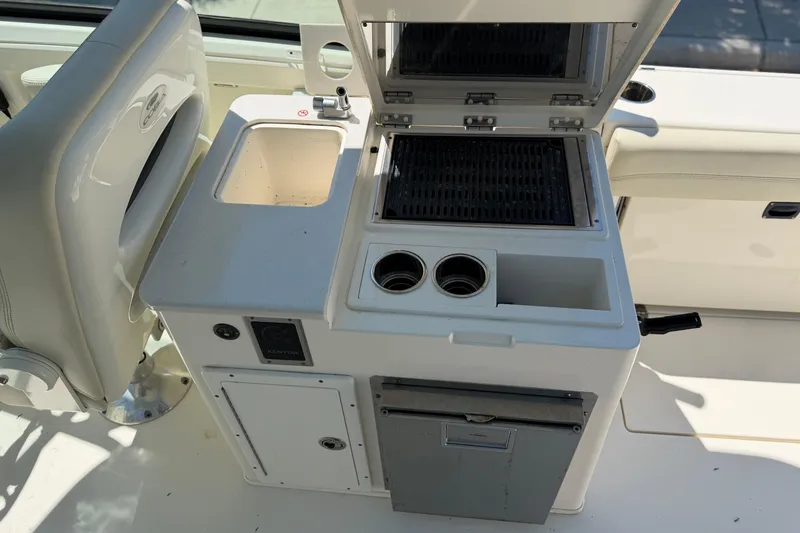 Slide: The Image of 2021 Cobia 280 Dual Console boat with onboard grill and sink station. - 14