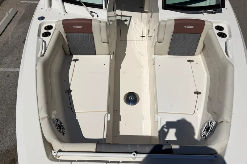Slide: The Image of 2021 Cobia 280 Dual Console boat interior with cushioned seating and cup holders. - 17