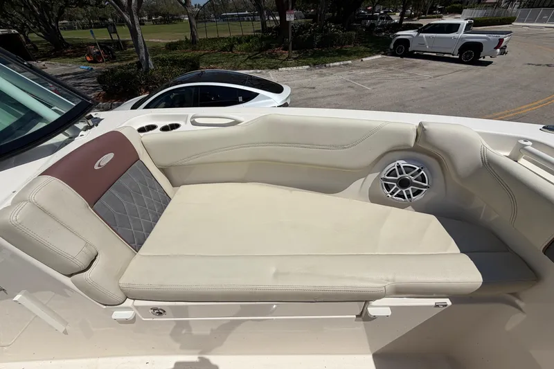 Slide: The Image of 2021 Cobia 280 Dual Console boat with cushioned seating and speaker detail. - 20