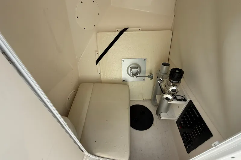 Slide: The Image of Interior of a 2021 Cobia 280 Dual Console boat, featuring seating and control panel. - 23