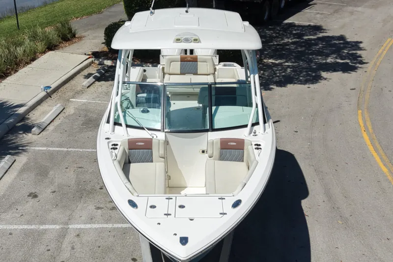 Slide: The Image of 2021 Cobia 280 Dual Console boat parked on a street, aerial view. - 3