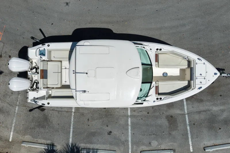 Slide: The Image of Overhead view of 2021 Cobia 280 Dual Console boat in parking lot. - 4