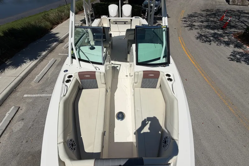 Slide: The Image of 2021 Cobia 280 Dual Console boat with spacious seating and open deck layout. - 6