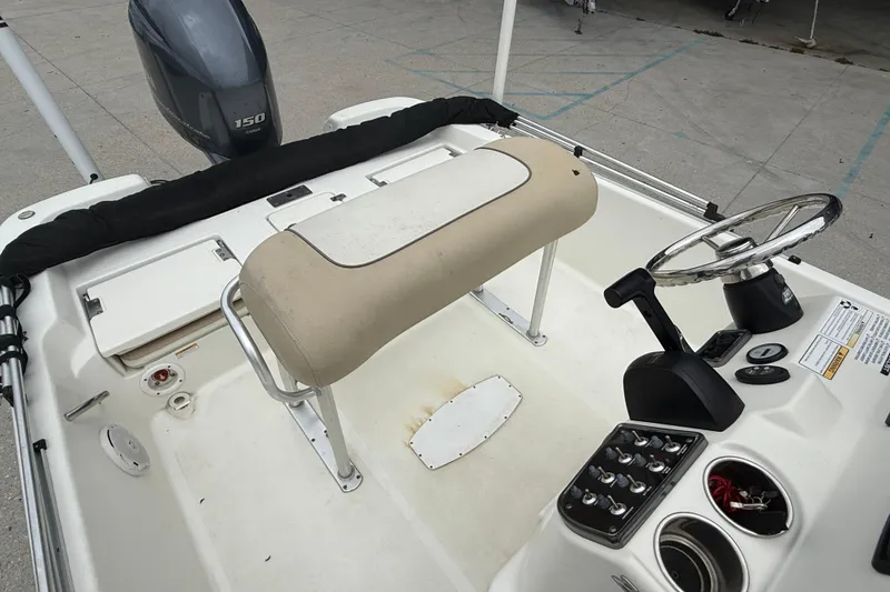 Slide: The Image of 2018 NauticStar 2140 Sport boat interior with steering wheel and control panel. - 12