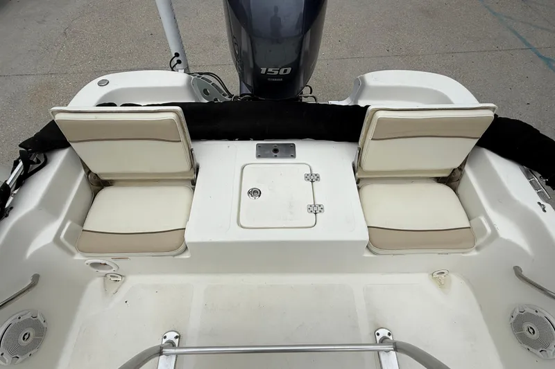 Slide: The Image of 2018 NauticStar 2140 Sport boat interior with seating and motor. - 13