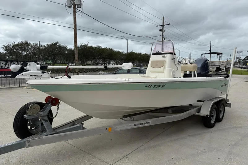 Slide: The Image of 2018 NauticStar 2140 Sport boat on trailer, featuring Minn Kota trolling motor. - 3
