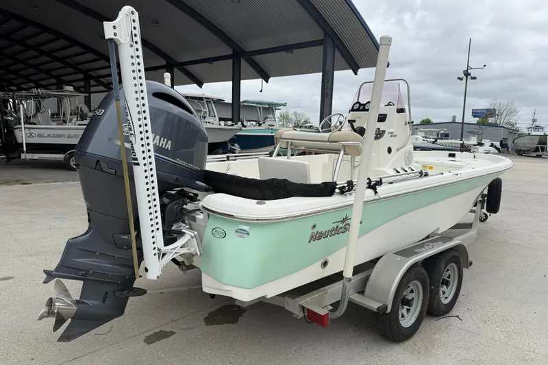 Slide: The Image of 2018 NauticStar 2140 Sport boat with Yamaha engine on trailer, parked under a canopy. - 6