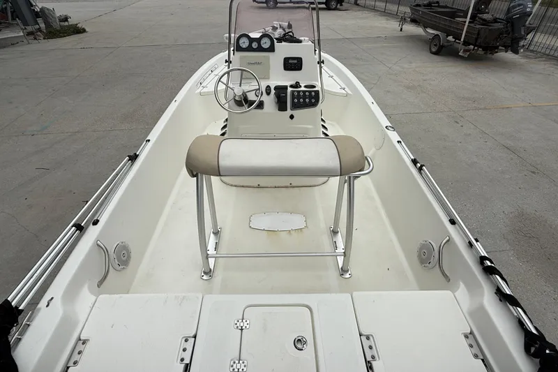 Slide: The Image of 2018 NauticStar 2140 Sport boat interior with steering console and seating. - 7