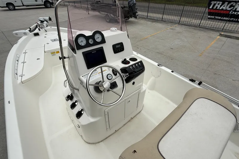 Slide: The Image of 2018 NauticStar 2140 Sport boat interior with steering console and seating. - 8