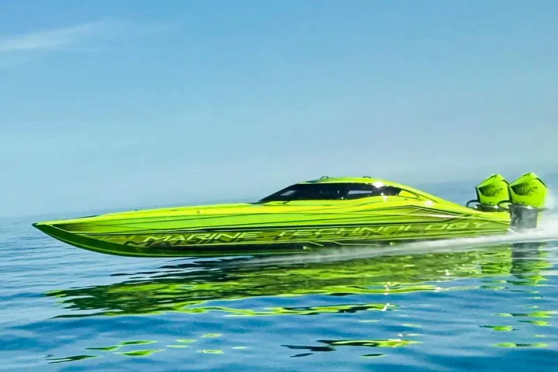 The Image of Bright green 2023 MTI 390XR speedboat gliding on calm blue water. - 0