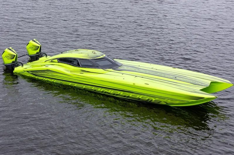 Slide: The Image of Bright green 2023 MTI 390XR speedboat with dual engines on water. - 13
