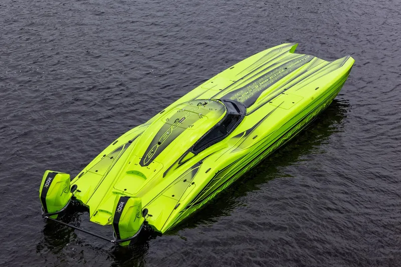 Slide: The Image of Bright green 2023 MTI 390XR powerboat on water, showcasing sleek design and dual engines. - 16