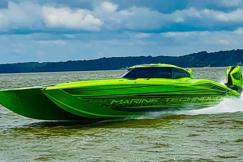 Slide: The Image of Interior of 2023 MTI 390XR boat with neon green accents and advanced navigation system. - 8