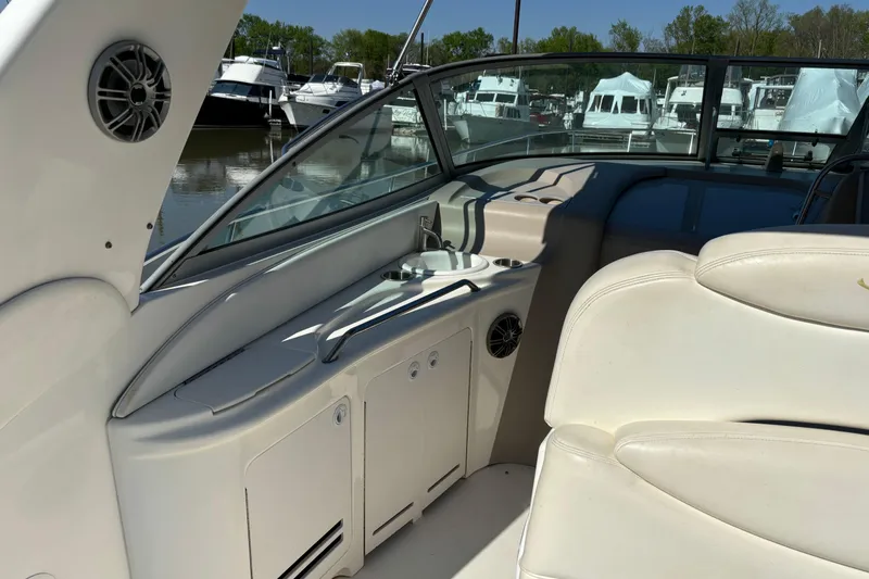 Slide: The Image of Interior view of a 2001 Sea Ray 340 Sundancer boat, featuring white seating and a sleek design. - 3