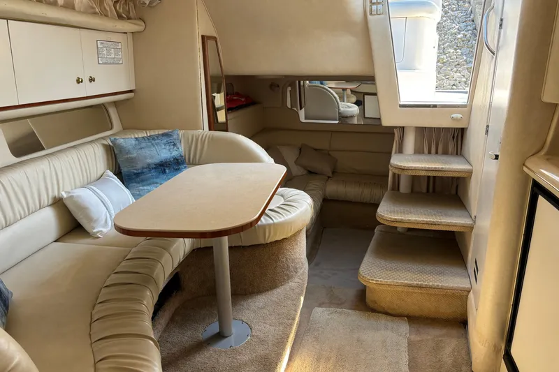 Slide: The Image of Interior of a 2001 Sea Ray 340 Sundancer yacht with beige seating and table. - 6