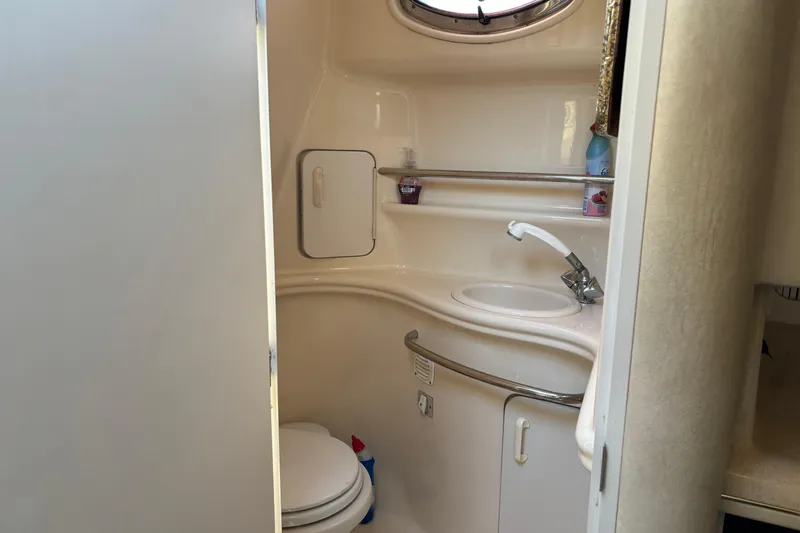 Slide: The Image of 2001 Sea Ray 340 Sundancer bathroom with sink, toilet, and storage cabinet. - 7