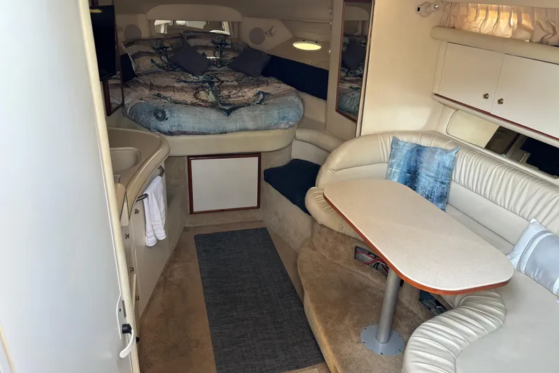 Slide: The Image of Interior of 2001 Sea Ray 340 Sundancer yacht with cozy seating and sleeping area. - 9
