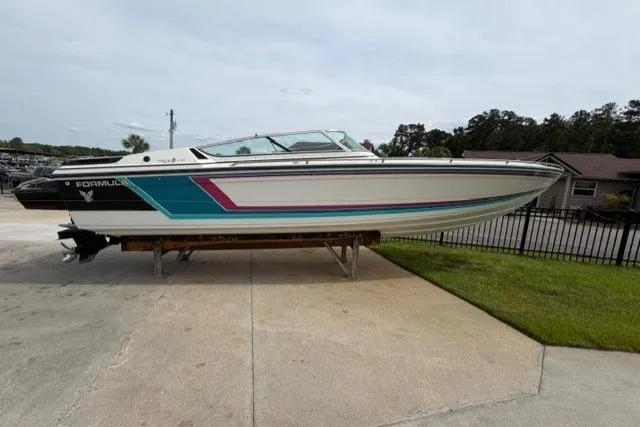 The Image of 1989 Formula 292 SR-1 boat on display, featuring vibrant teal and pink accents. - 1