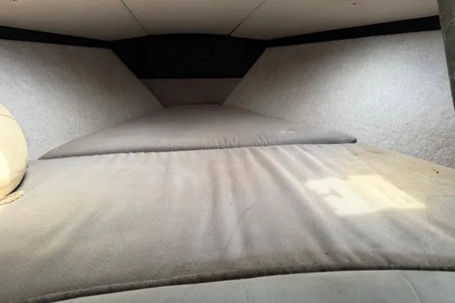 Slide: The Image of Interior cabin of a 1989 Formula 292 SR-1 boat, featuring cushioned seating. - 12