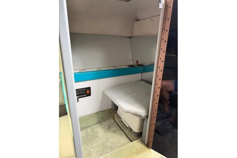 Slide: The Image of Interior cabin of a 1989 Formula 292 SR-1 boat, featuring seating and storage. - 14