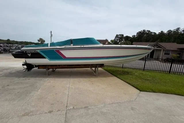 Slide: The Image of 1989 Formula 292 SR-1 boat on display, featuring a sleek design and vibrant accents. - 19