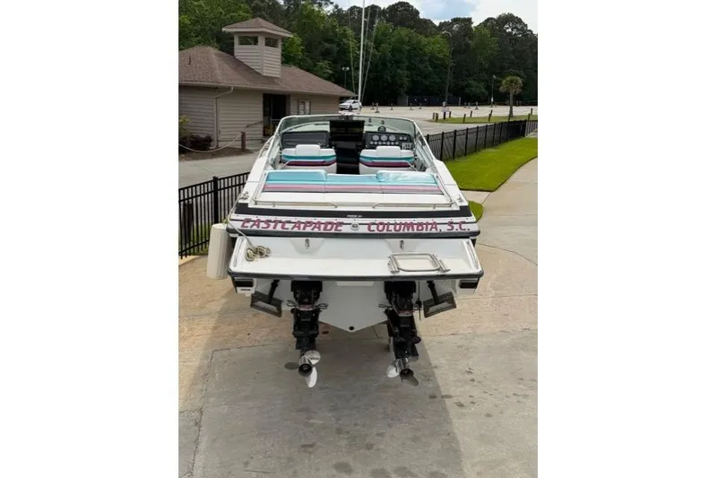 Slide: The Image of 1989 Formula 292 SR-1 boat with twin engines, docked near a building. - 3