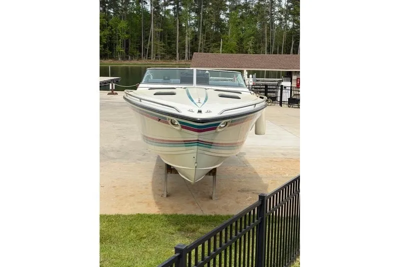 Slide: The Image of 1989 Formula 292 SR-1 boat on display near a lake with trees in the background. - 4